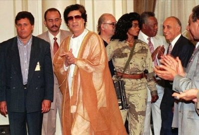 Gaddafi in the 1980's wearing something inspried by Prince - Via Flickr