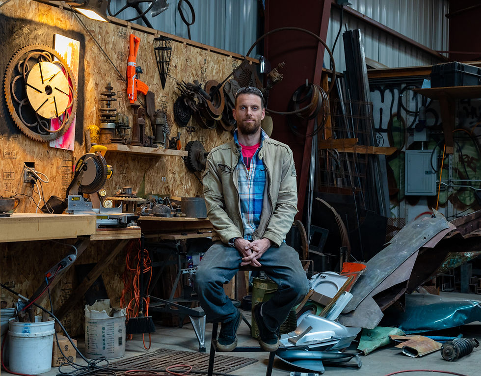 Brian Enright sits in his shop