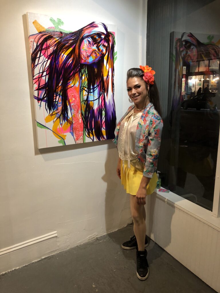 Chloe poses next to her favorite Tracy Piper painting at "Bloom" in a throwback vintage look 