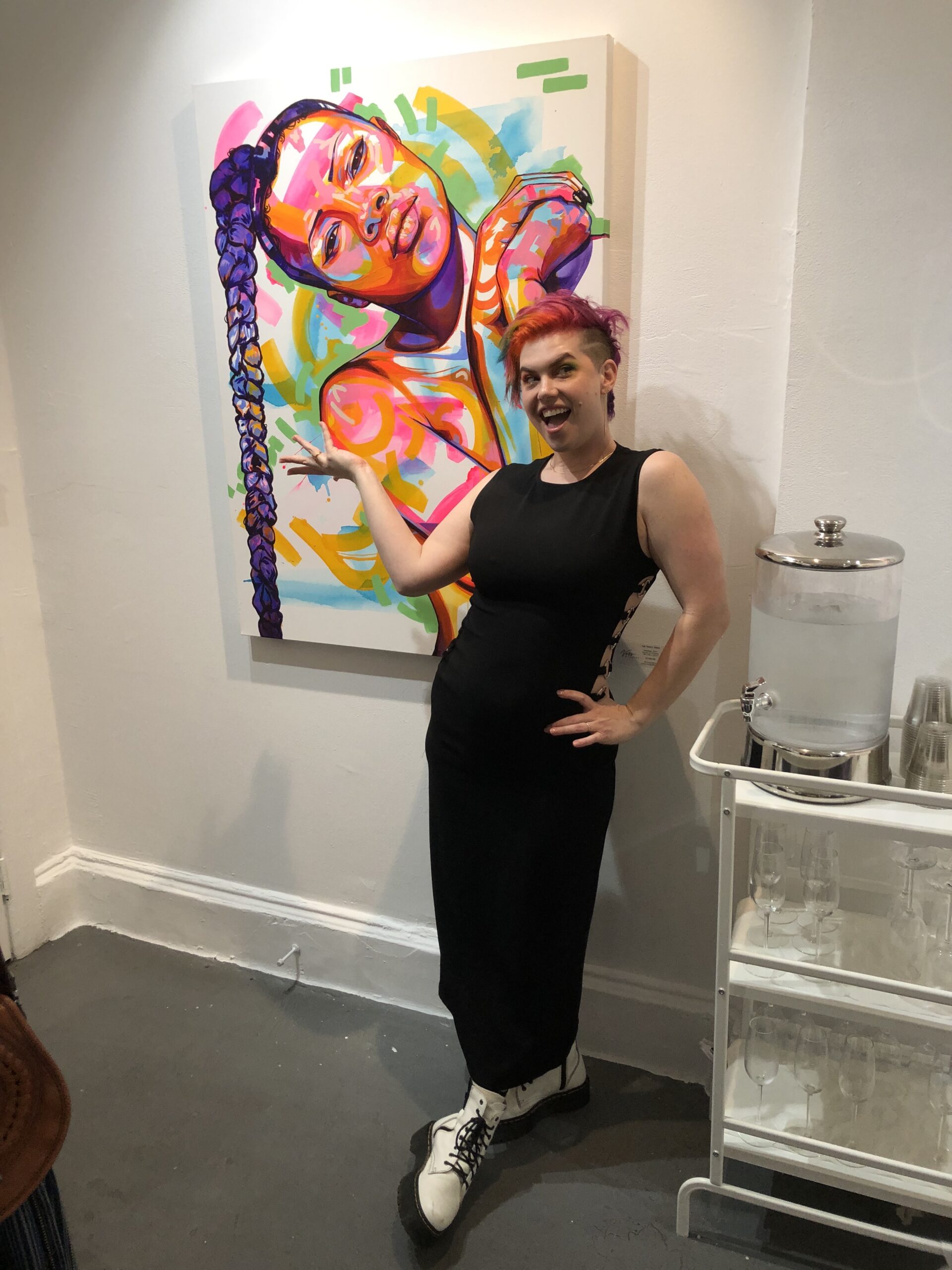 Bay Area Artist Tracy Piper stands in front her piece