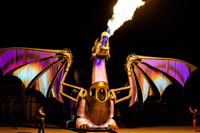 large dragon art car breaths fire wile illuminated