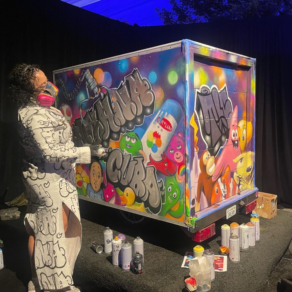 Artist Agana painted graffiti on the MoMA derby boxcar live at the Art Bash