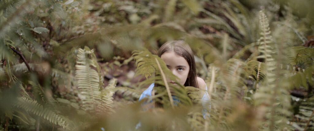young girl hiding in the ferns