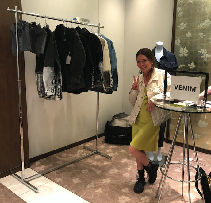 Venim designer Leslie Fong poses with a rack of her metalized denim jacket
