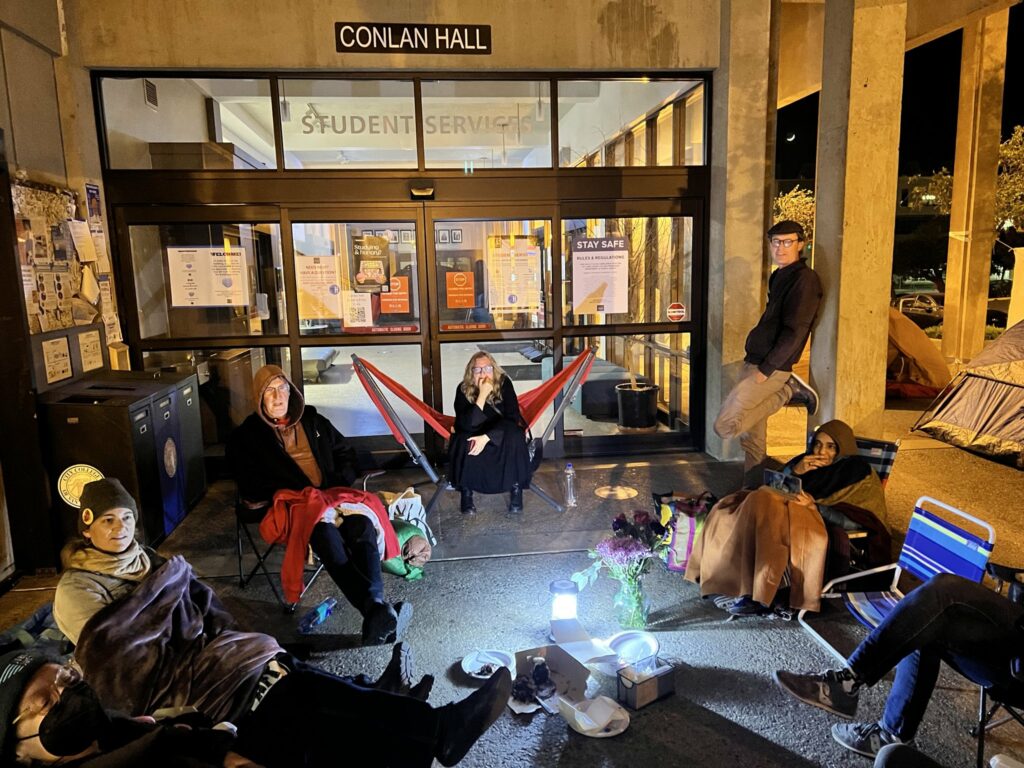 faculty outside of Conlan Hall at City College camp out