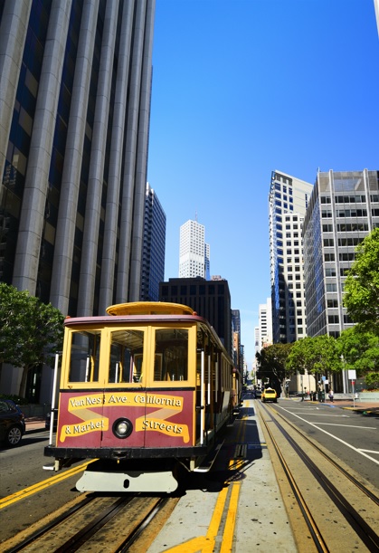 A cable car climbs California Street in San Francisco's Financial District.