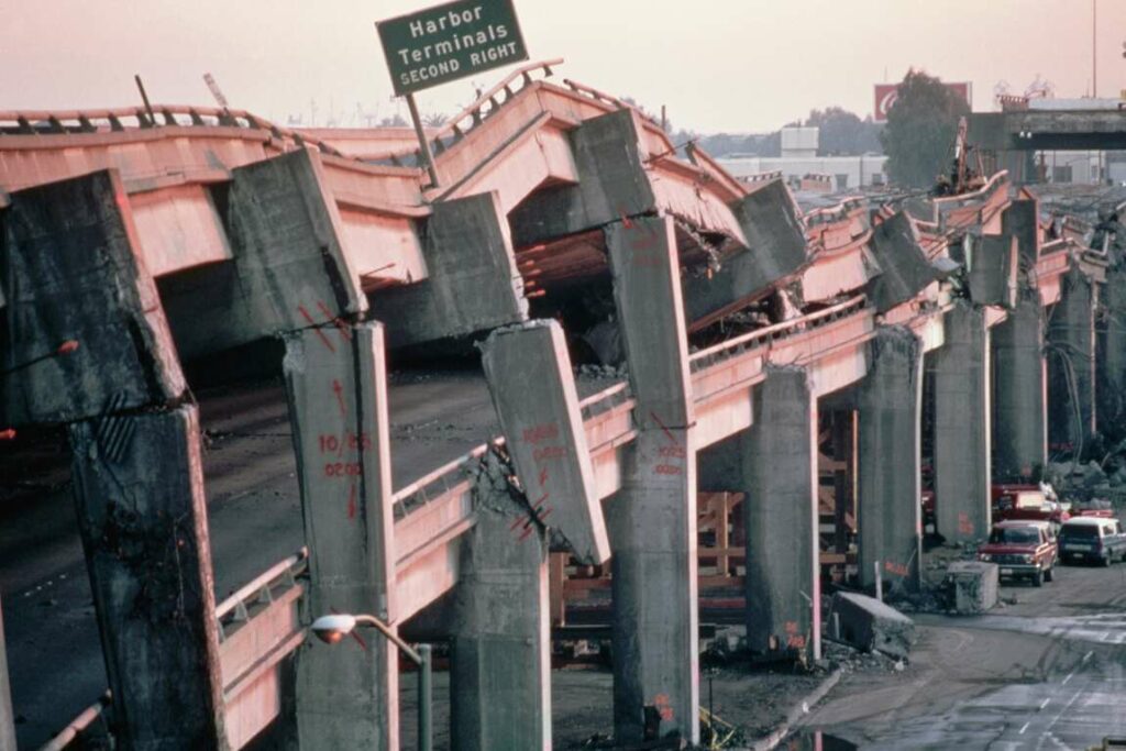 The former double-decker Cypress Street Viaduct shown collapsed and pancaked in the wake of the 1989 Loma Prieta earthquake.
