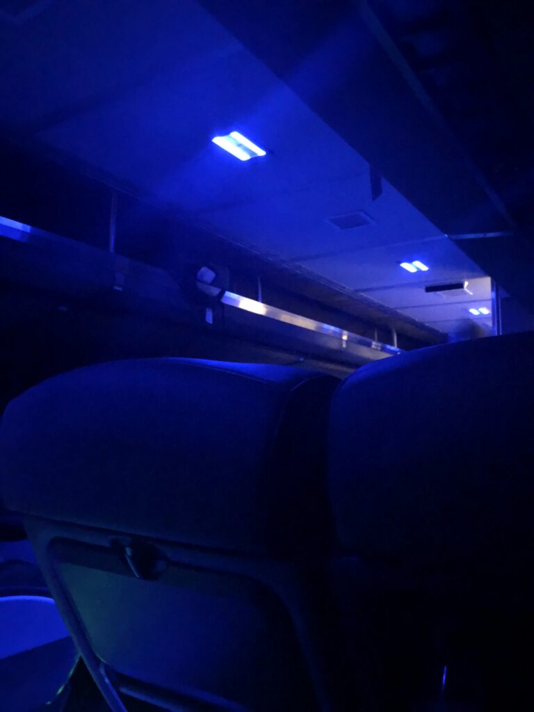 Blue tinted lights in the interior of an Amtrak train at night