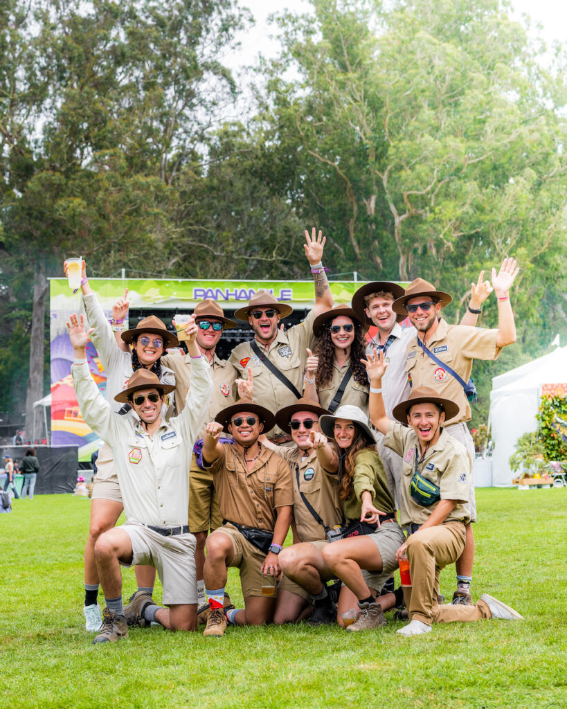 a large group of friends all vaguely dressed like park rangers
