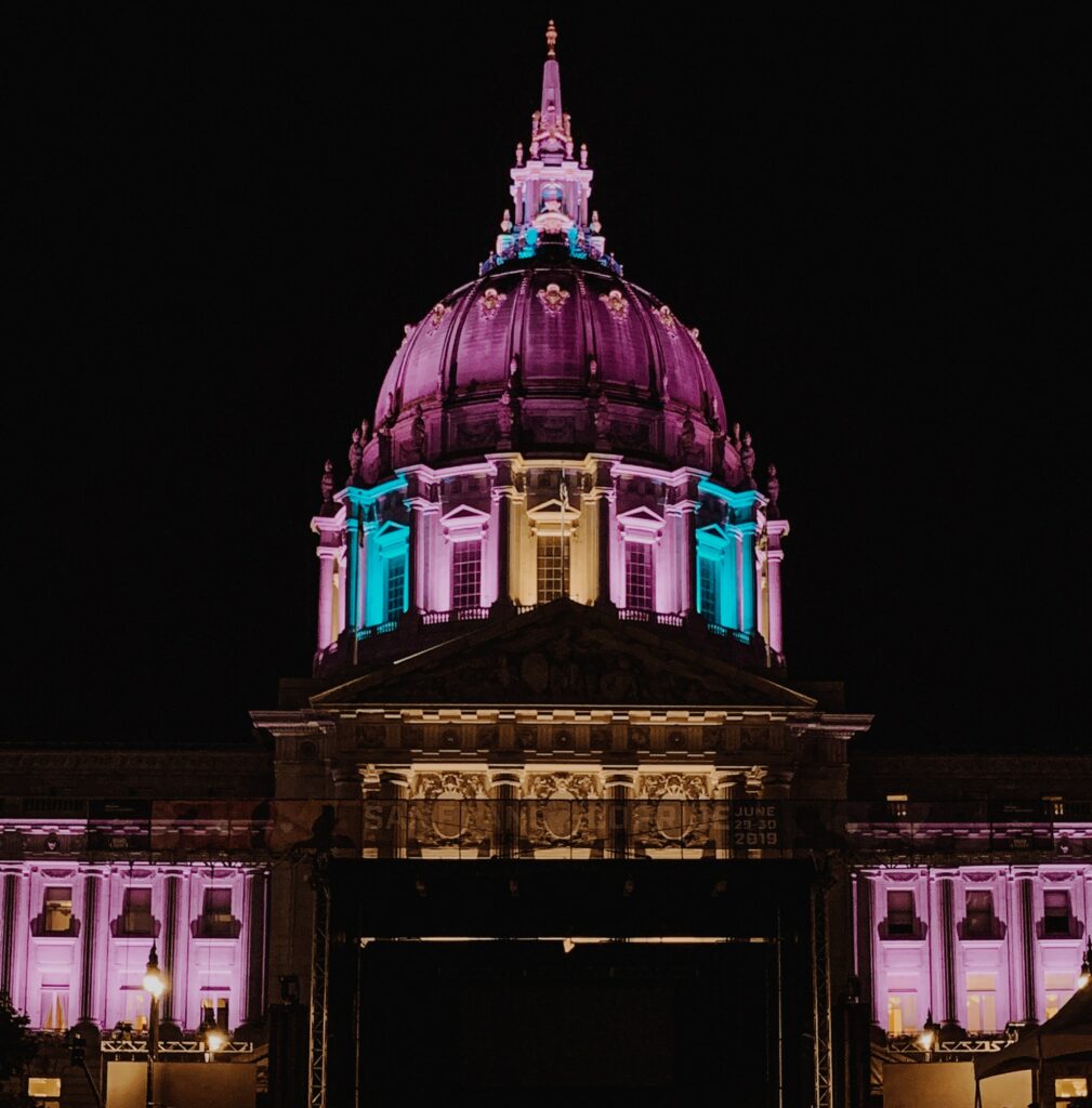 Photo of San Francisco City Hall lit up with the Trans Pride colors. This is being used to celebrate Transgender History Month