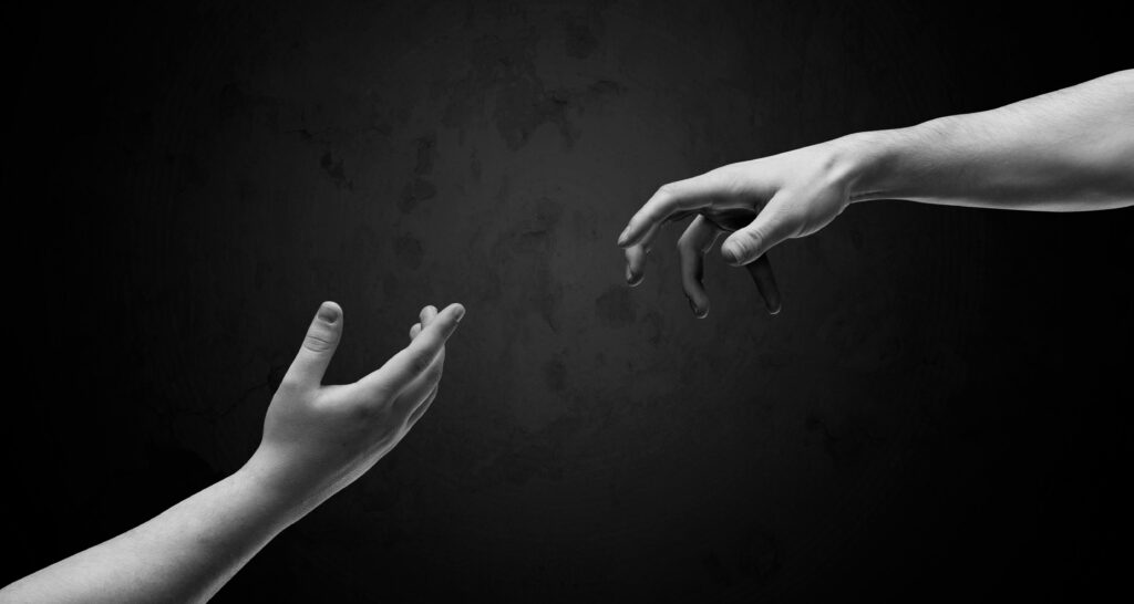 Hands almost touching or letting go, Shutterstock